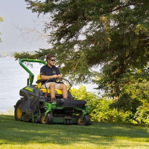 A male employee driving a lawnmower image